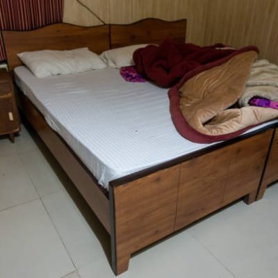 A morning bed with scattered sheets and covers in an Indian setting.