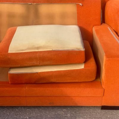 High angle close-up view of a broken sofa left in the street in the city of Valencia, Spain