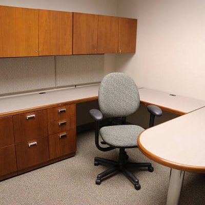 Office with just a desk, chair and cabinets.