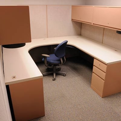 Office cubicle with nothing in it except a chair.
